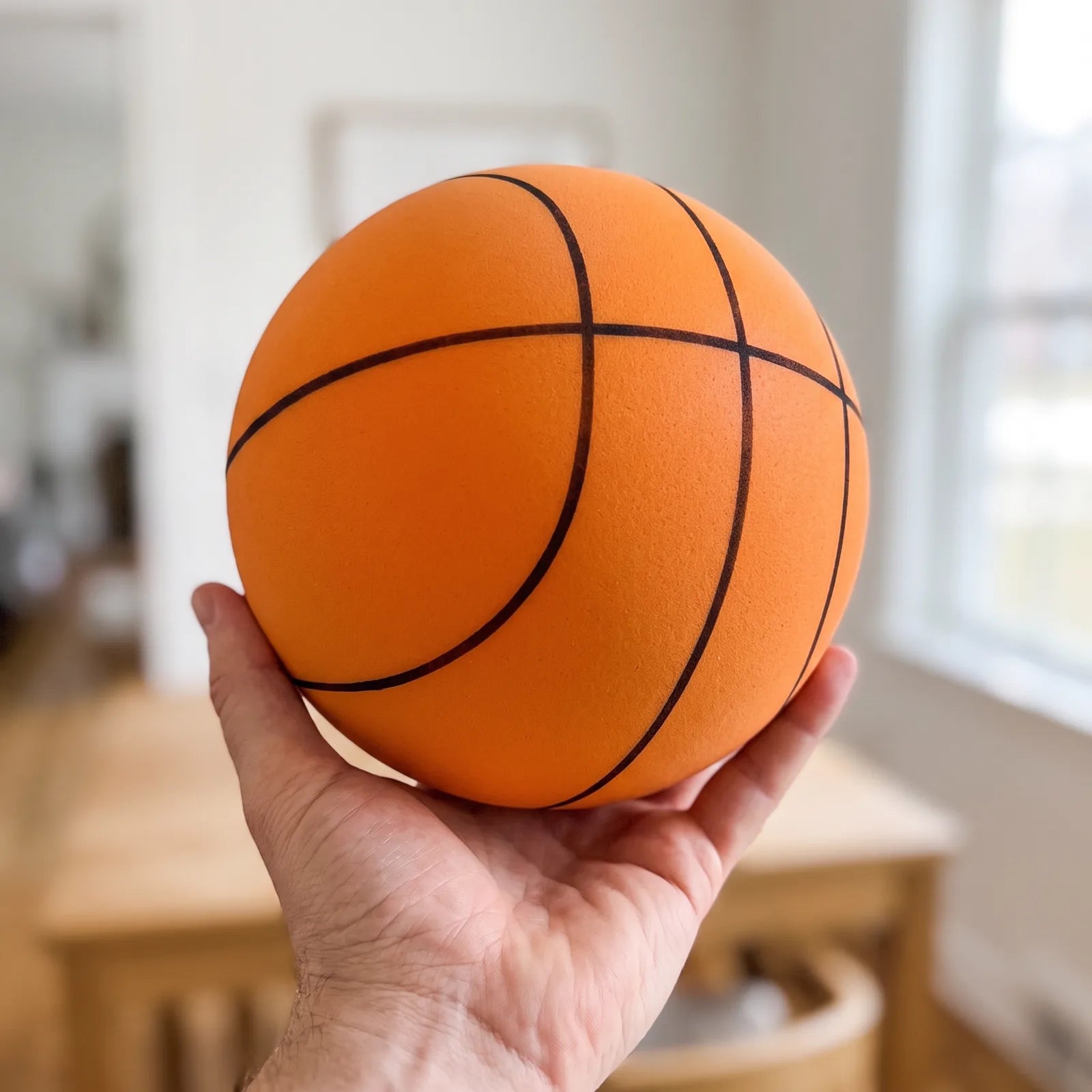 Hushoops Quiet Indoor Basketball held in one hand to show its size